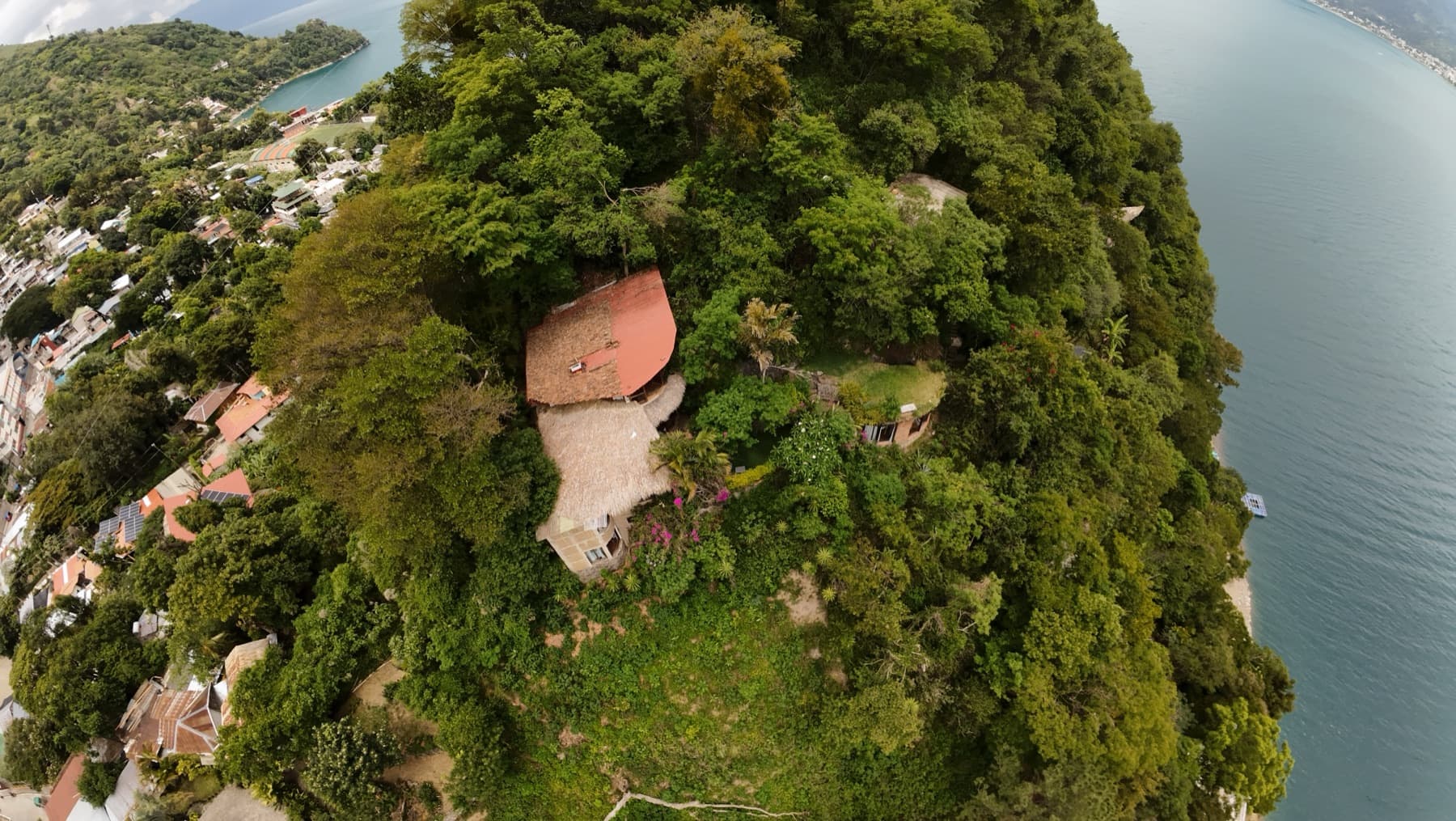 Aerial view of Hill of Dreams, a hillside estate above Lake Atitlán with San Pedro volcano across the water